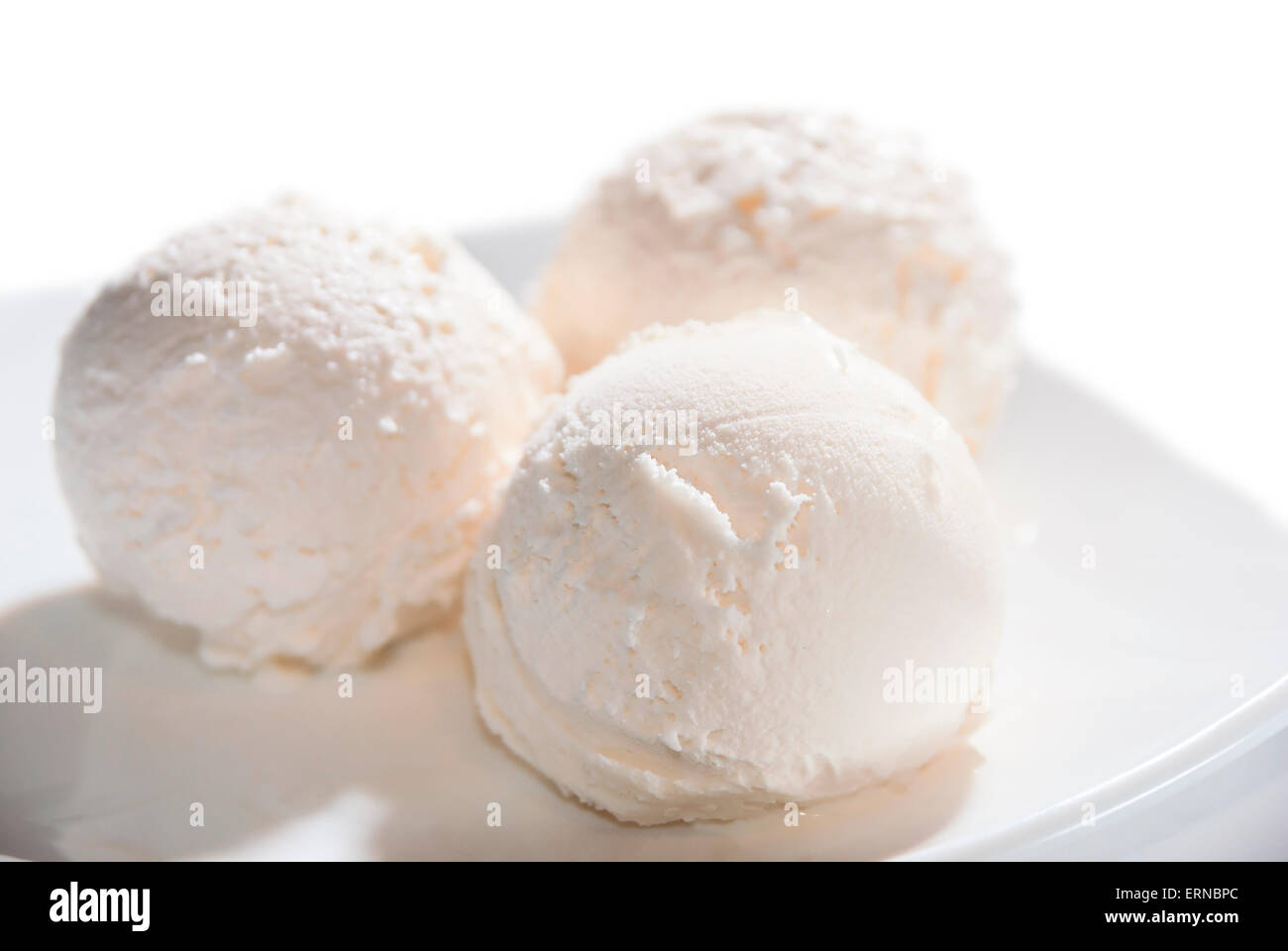 three balls of ice cream on a plate isolated Stock Photo