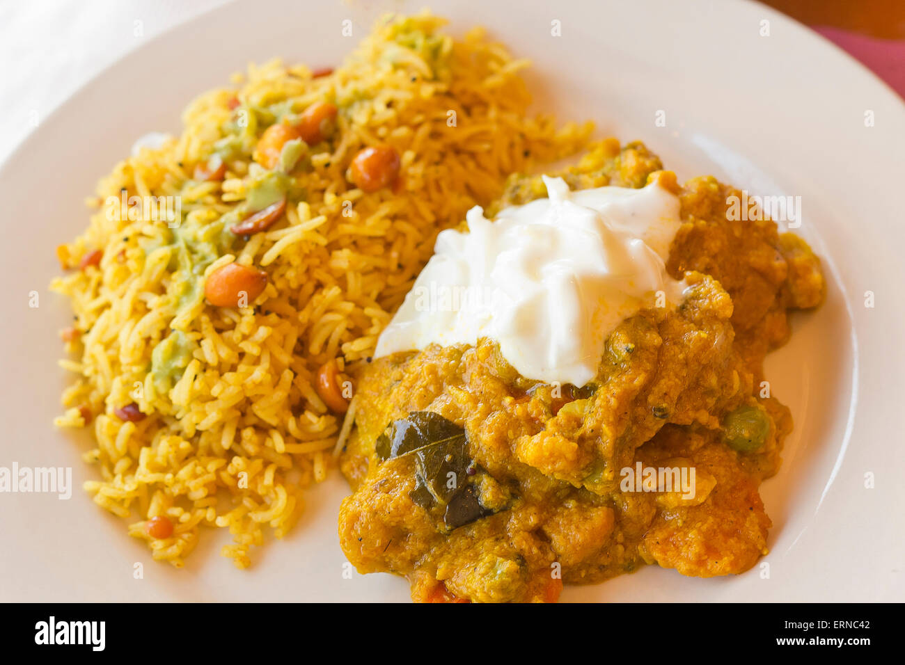 Authentic Indian vegetable Korma topped with yogurt sauce with a side