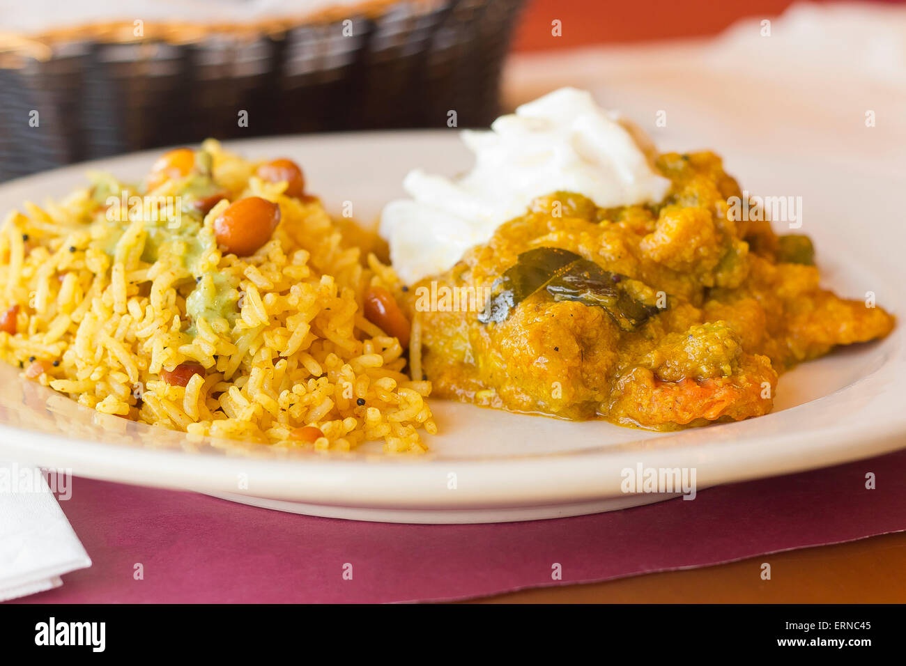 Authentic Indian vegetable Korma topped with yogurt sauce with a side