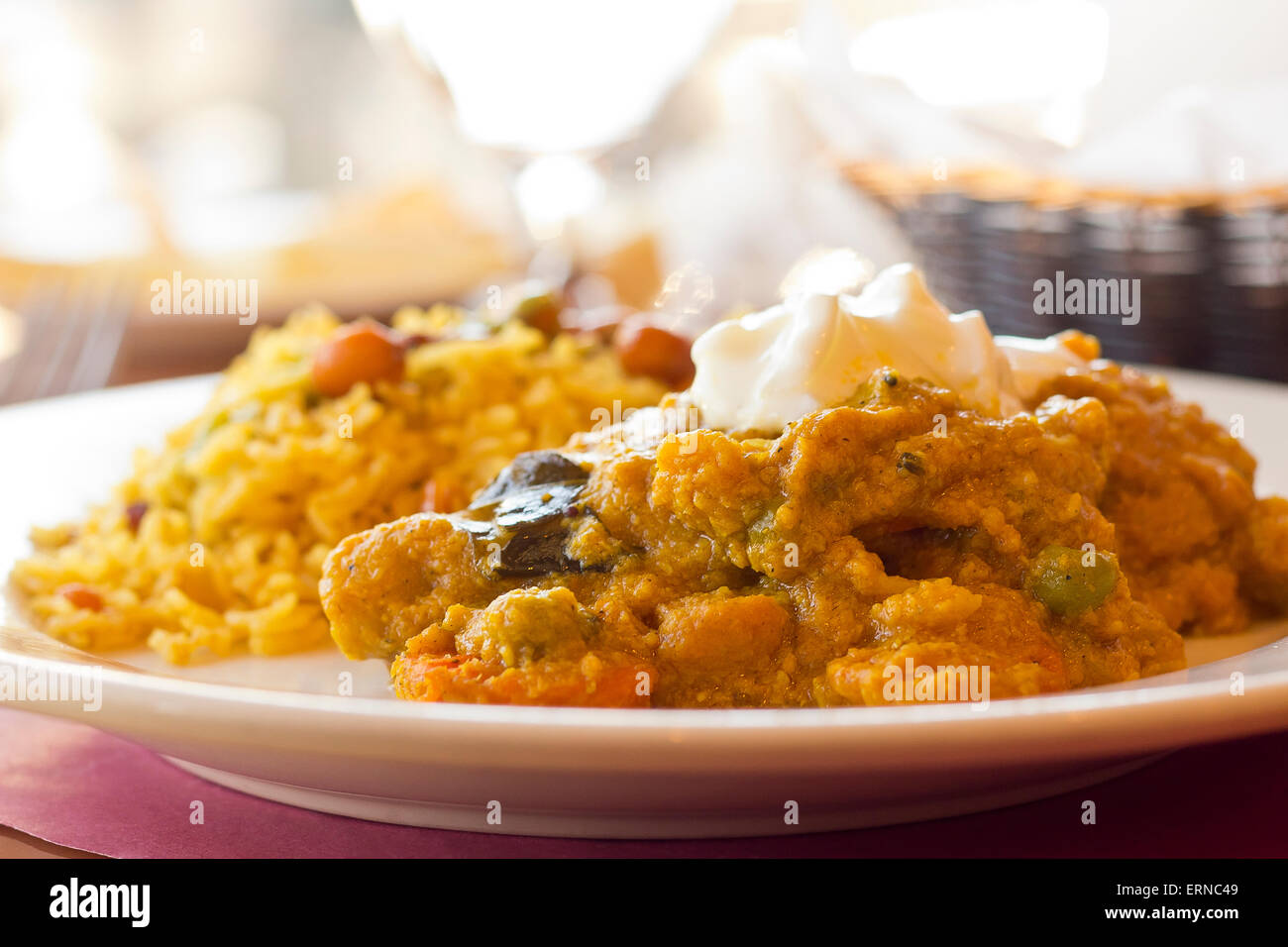 Authentic Indian vegetable Korma topped with yogurt sauce with a side