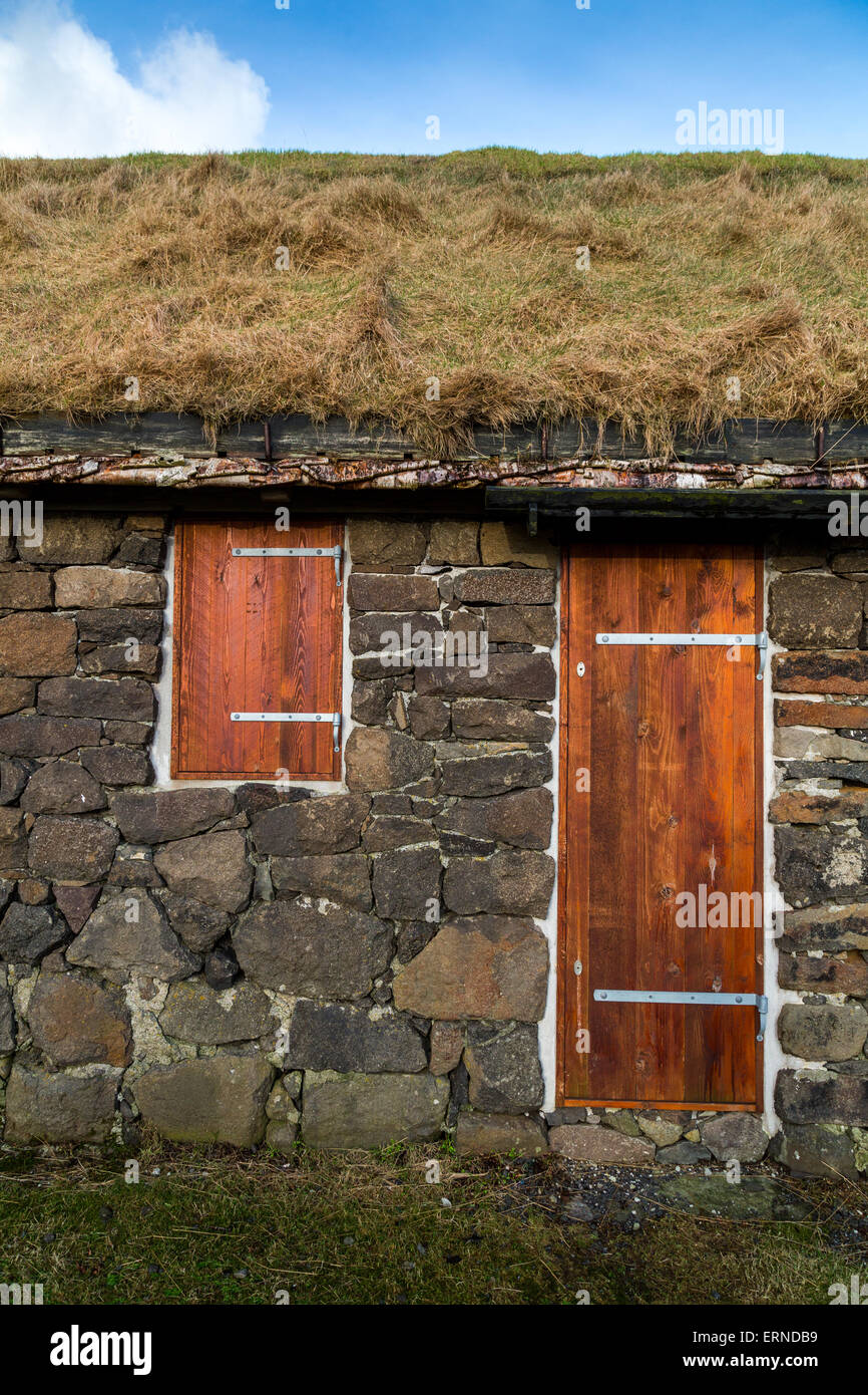 Facade of a typical rural building with natural grass roof and silver birch rafters in Torshavn, Faroe Islands Stock Photo