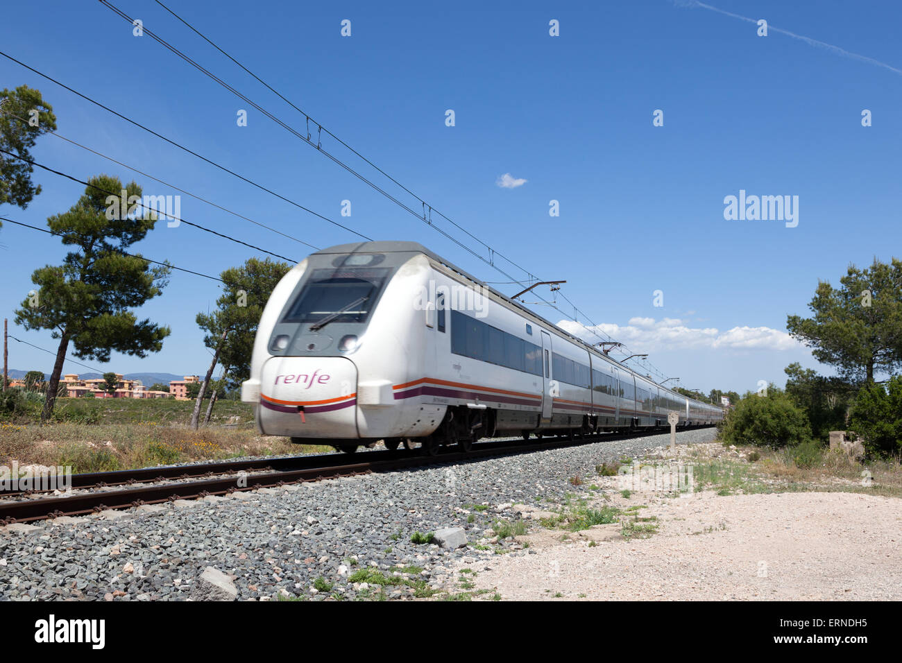 RENFE (Red Nacional de los Ferrocarriles Espanoles) passenger train passing by in Miami Platja. May 6, 2015 in Miami Platja, Spa Stock Photo