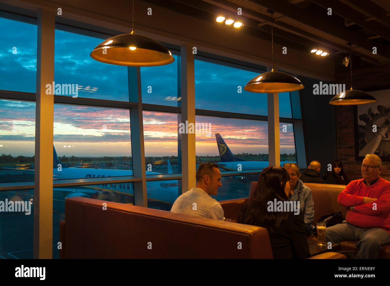 People relax drinking in a cafe bar in Dublin Airport departures Terminal One 1 early morning Stock Photo
