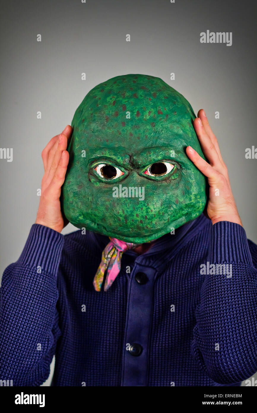 Creepy bald lizard man wearing a blue sweater Stock Photo - Alamy