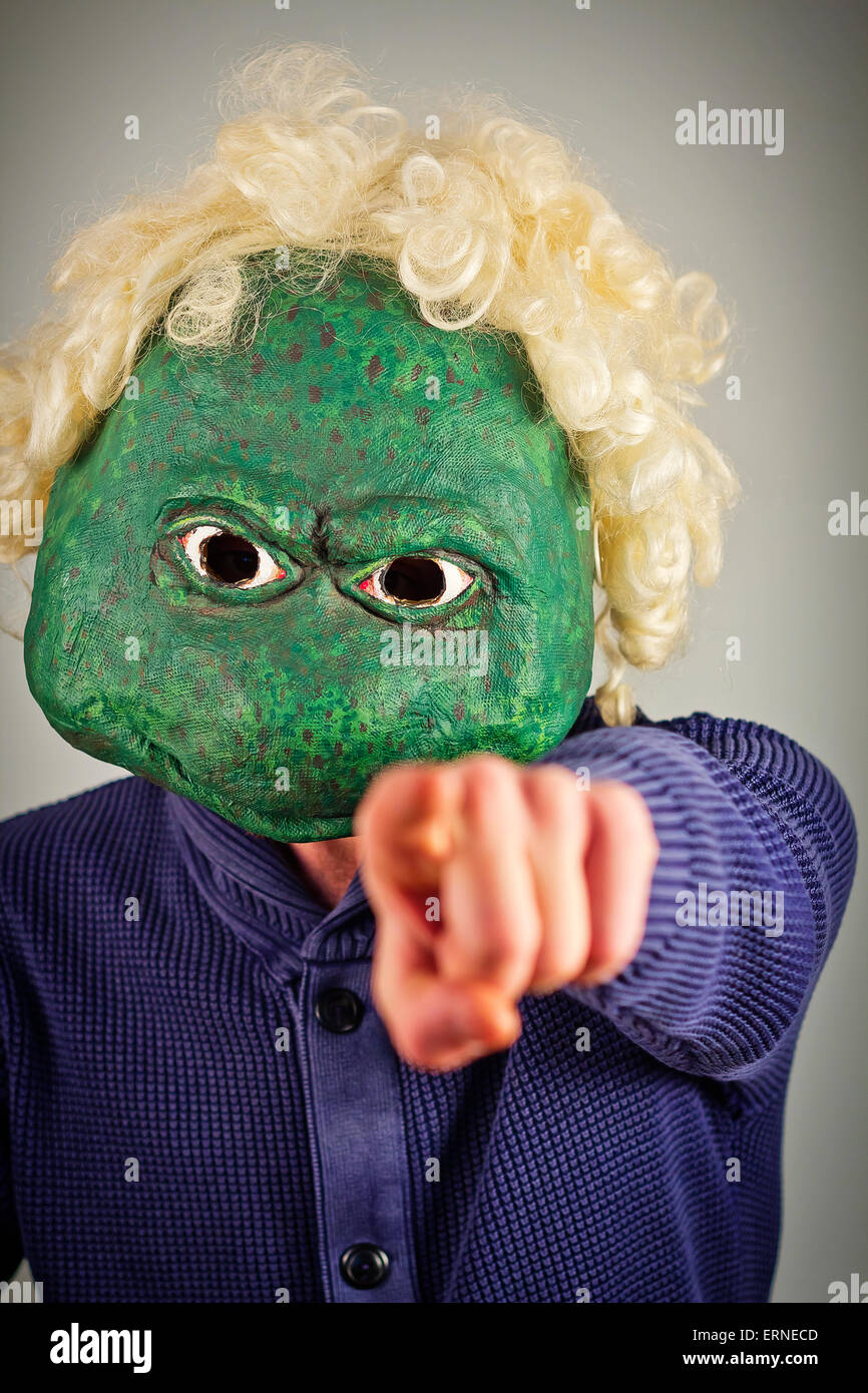 Creepy bald lizard man wearing a blue sweater Stock Photo - Alamy