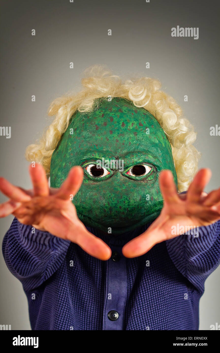 Creepy bald lizard man wearing a blue sweater Stock Photo - Alamy