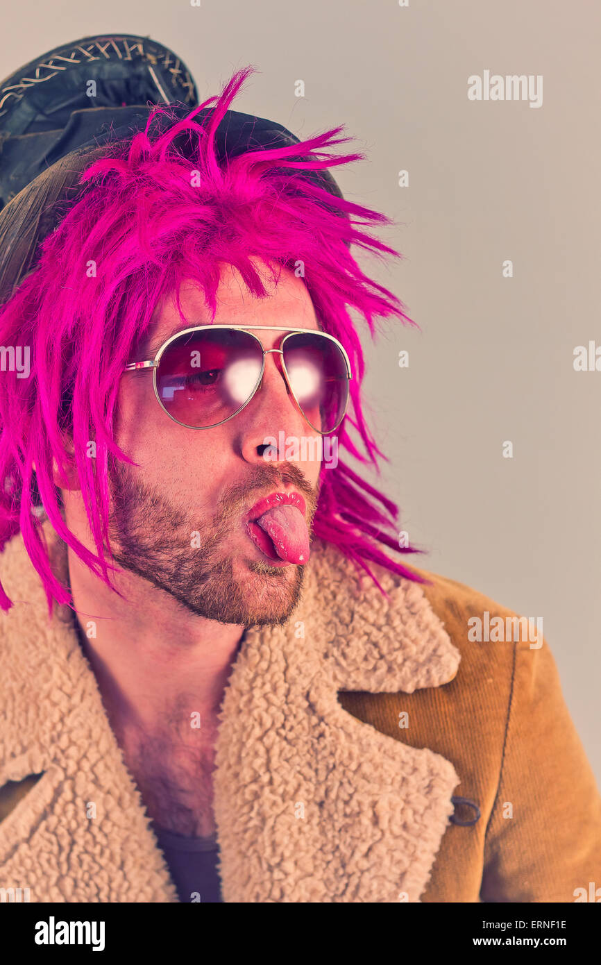Pink haired bearded bum lunatic man with cool sunglasses Stock Photo