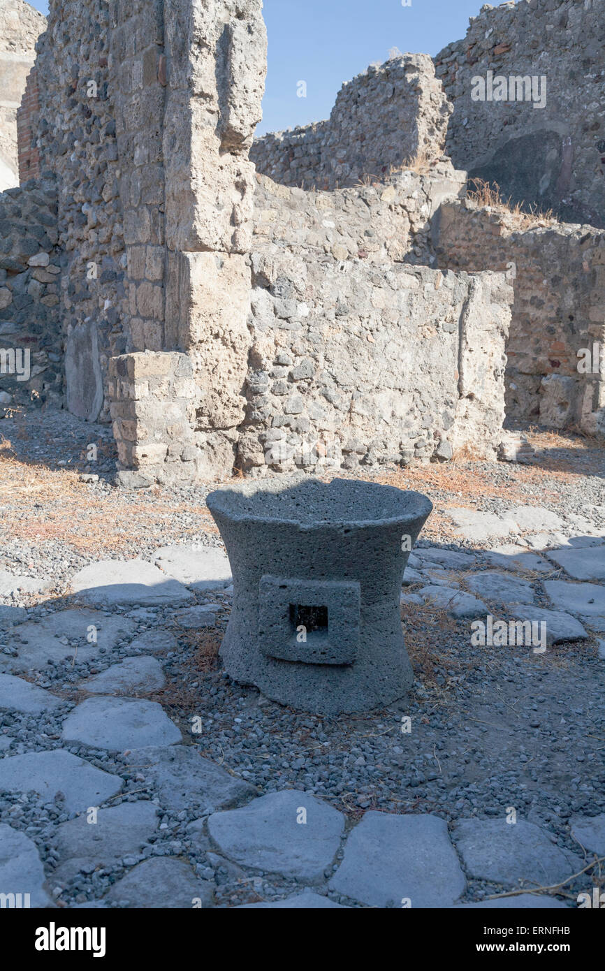 Hand corn milling stone. One of many millstones unearthed during the archaeological excavation of the city Stock Photo