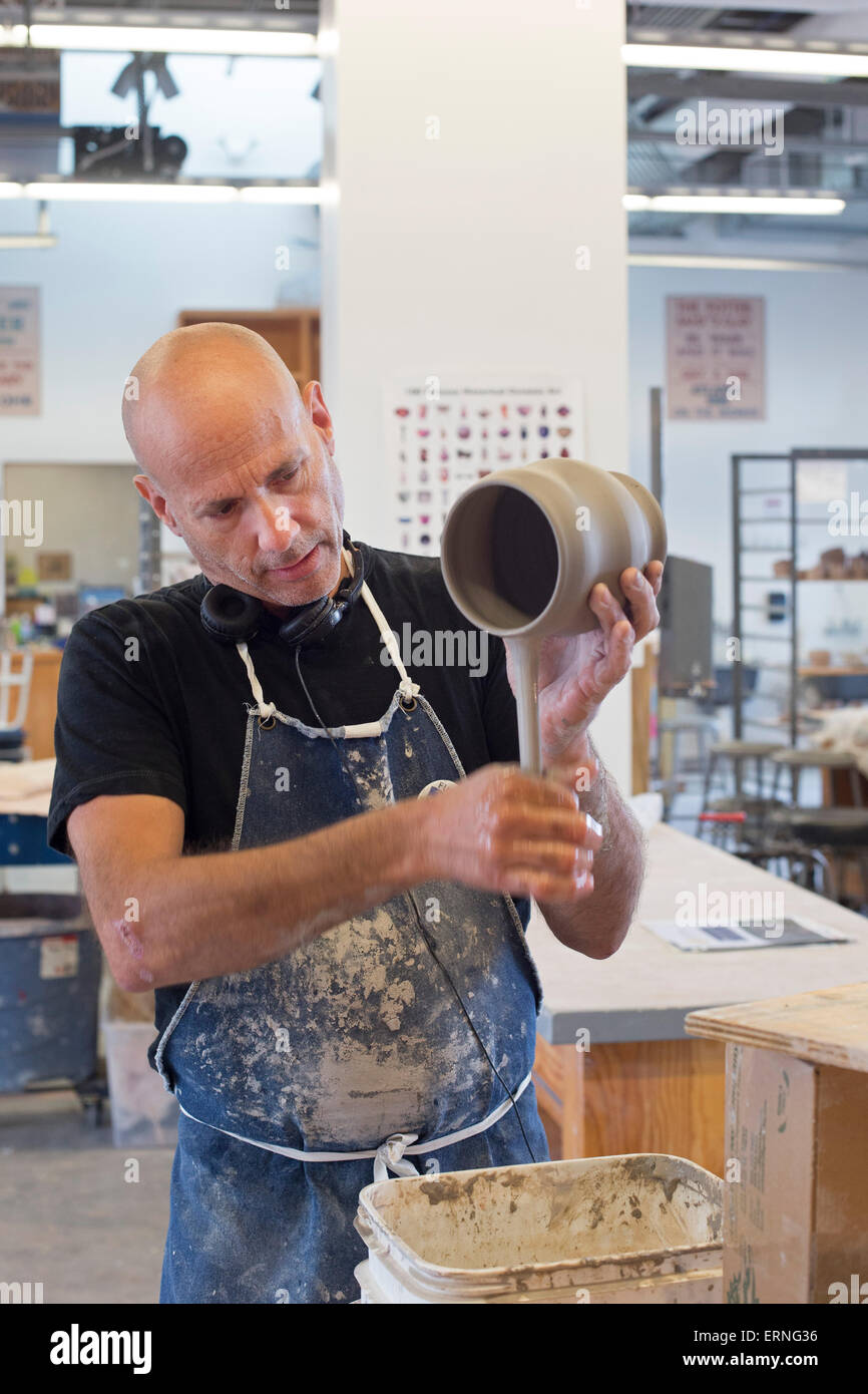 Biloxi, Mississippi - A potter works in the City of Biloxi Center for Ceramics at the Ohr-O'Keefe Museum of Art. Stock Photo