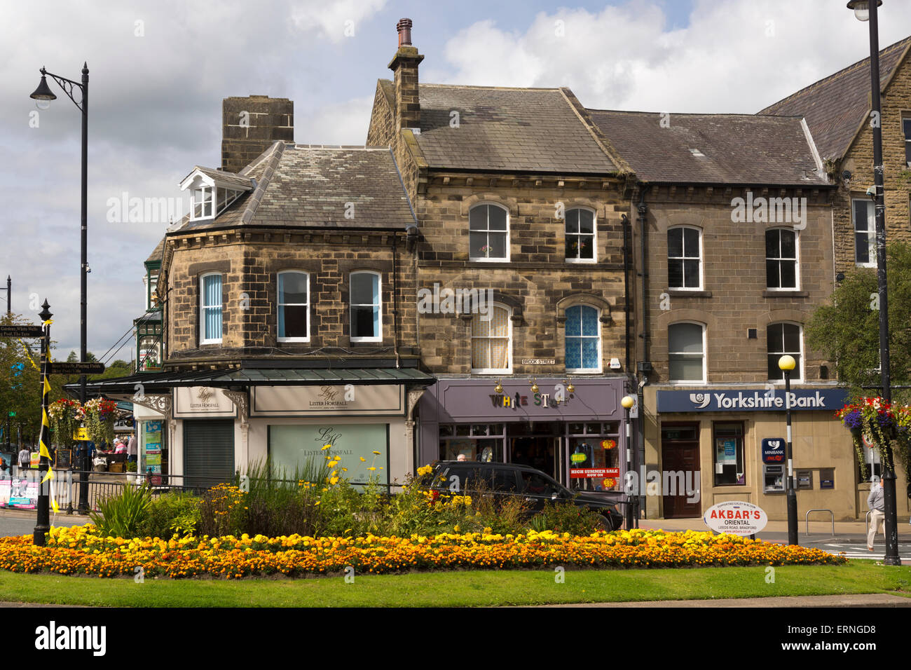 Ilkley in Bloom, typical Yorkshire sandstone buildings on Brook Street, Yorkshire, England Stock Photo