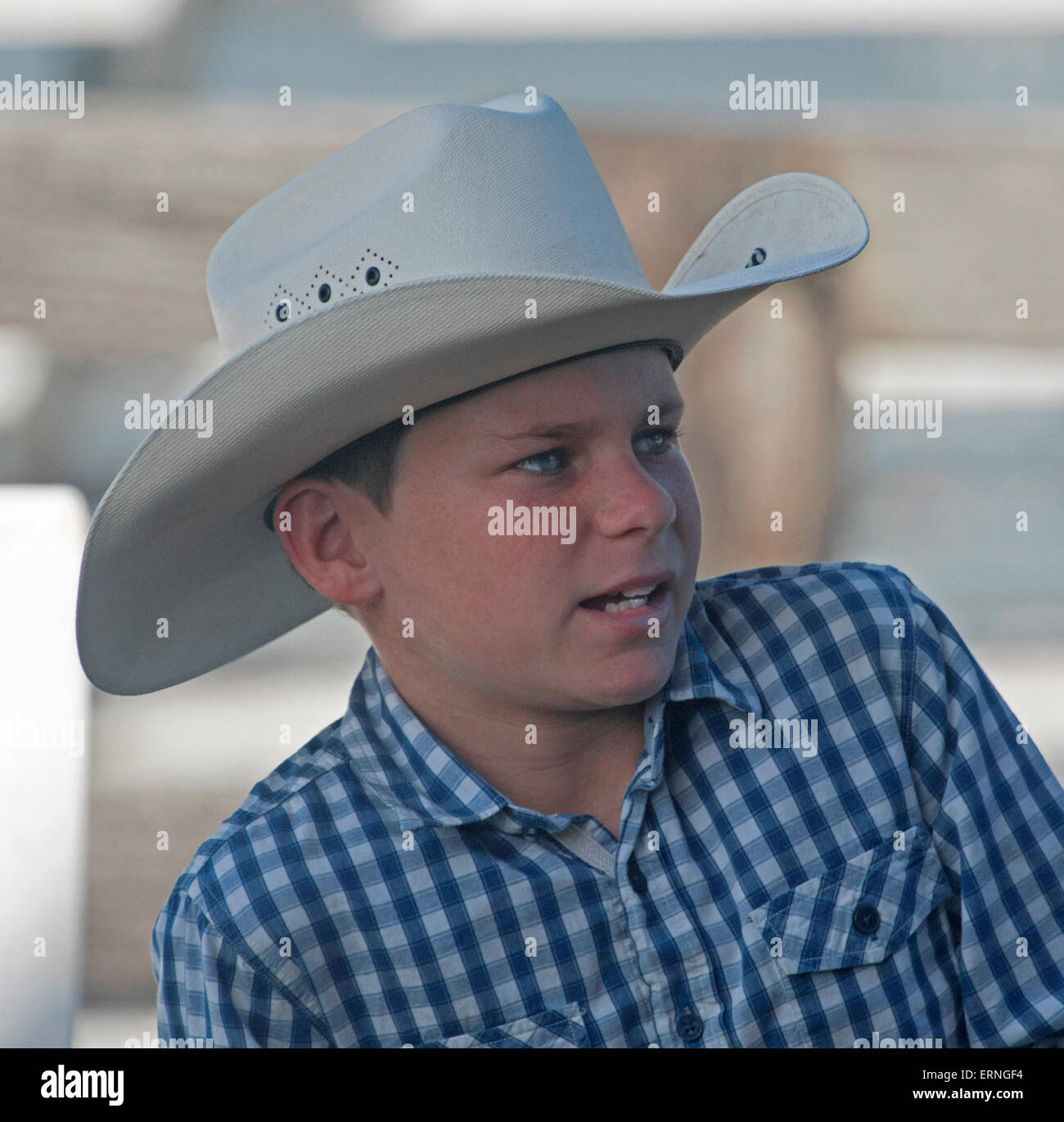 Young Australian boy wearing blue check shirt and wearing white western cowboy style akubra hat Stock Photo