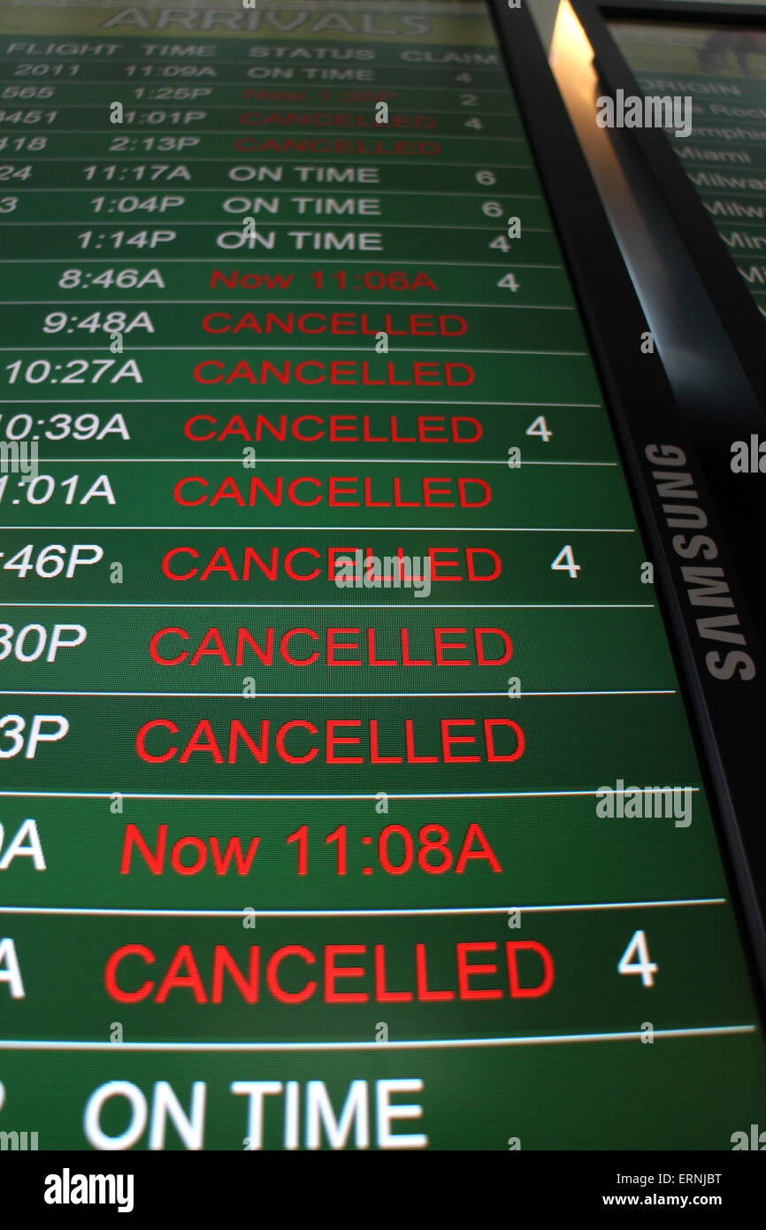 Canceled flights on airport flight status board Cincinnati Stock Photo