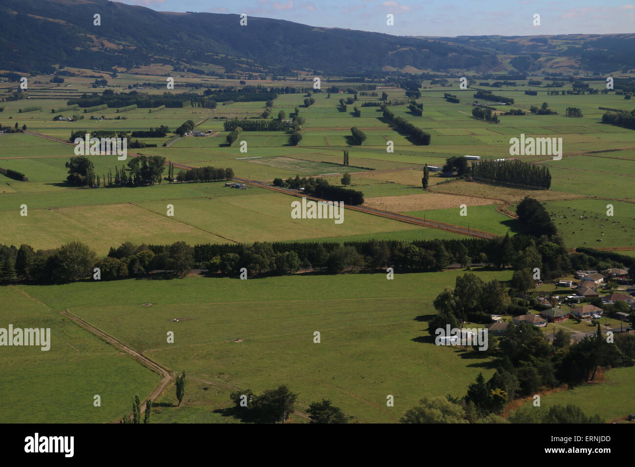 Aerial of farm land and pasture near mountains south island New Zealand Stock Photo