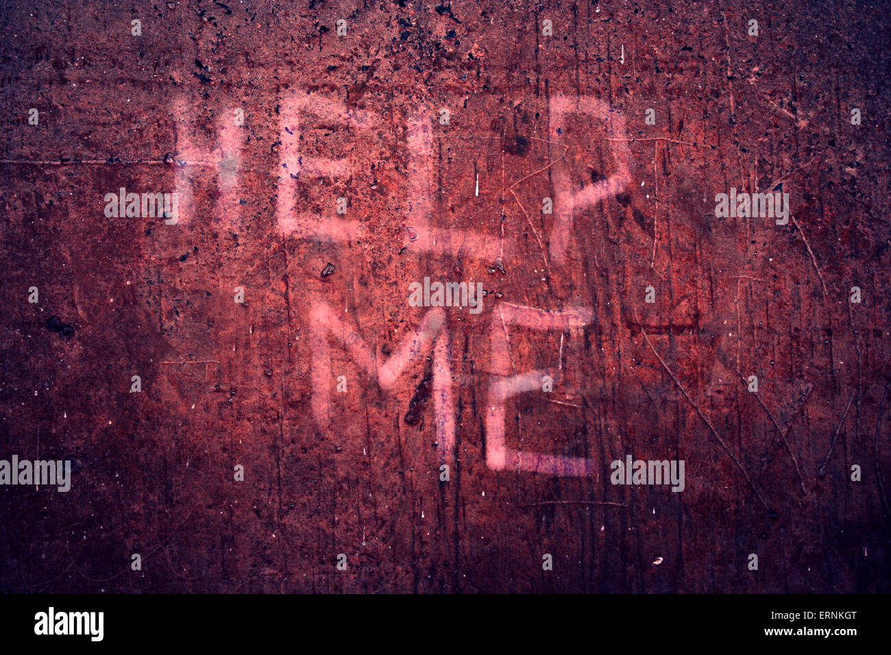Altered photo of a dank concrete cellar wall with words HELP ME. Stock Photo