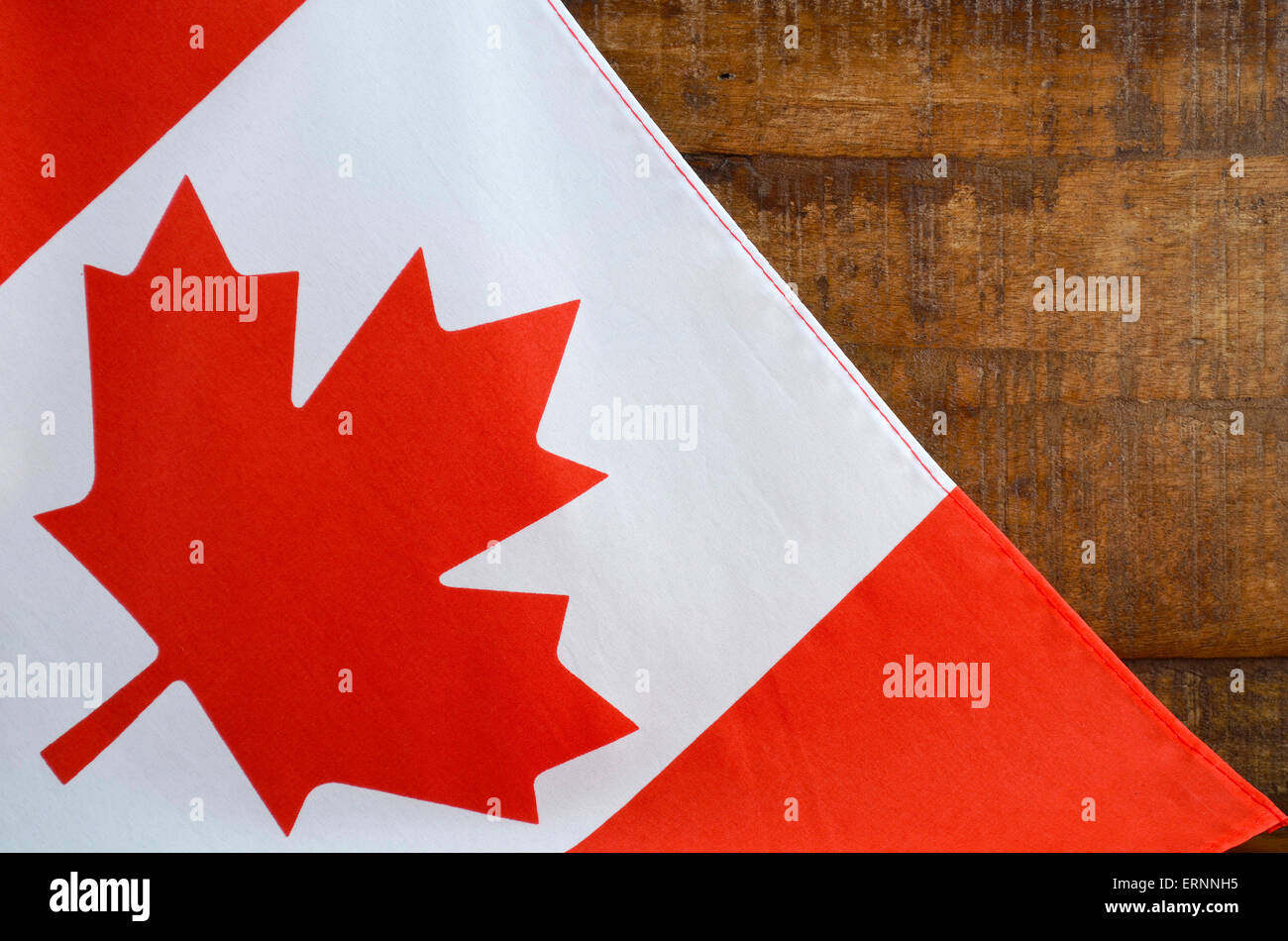 Canadian red and white maple leaf flag against dark wood rustic background for Canada Day, July 1, celebration and national holi Stock Photo