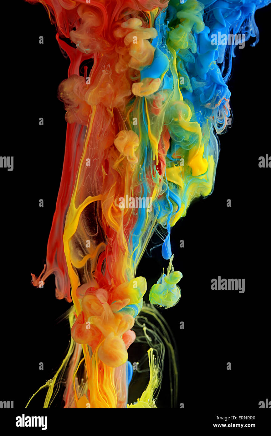 Colorful ink swirling through water Stock Photo