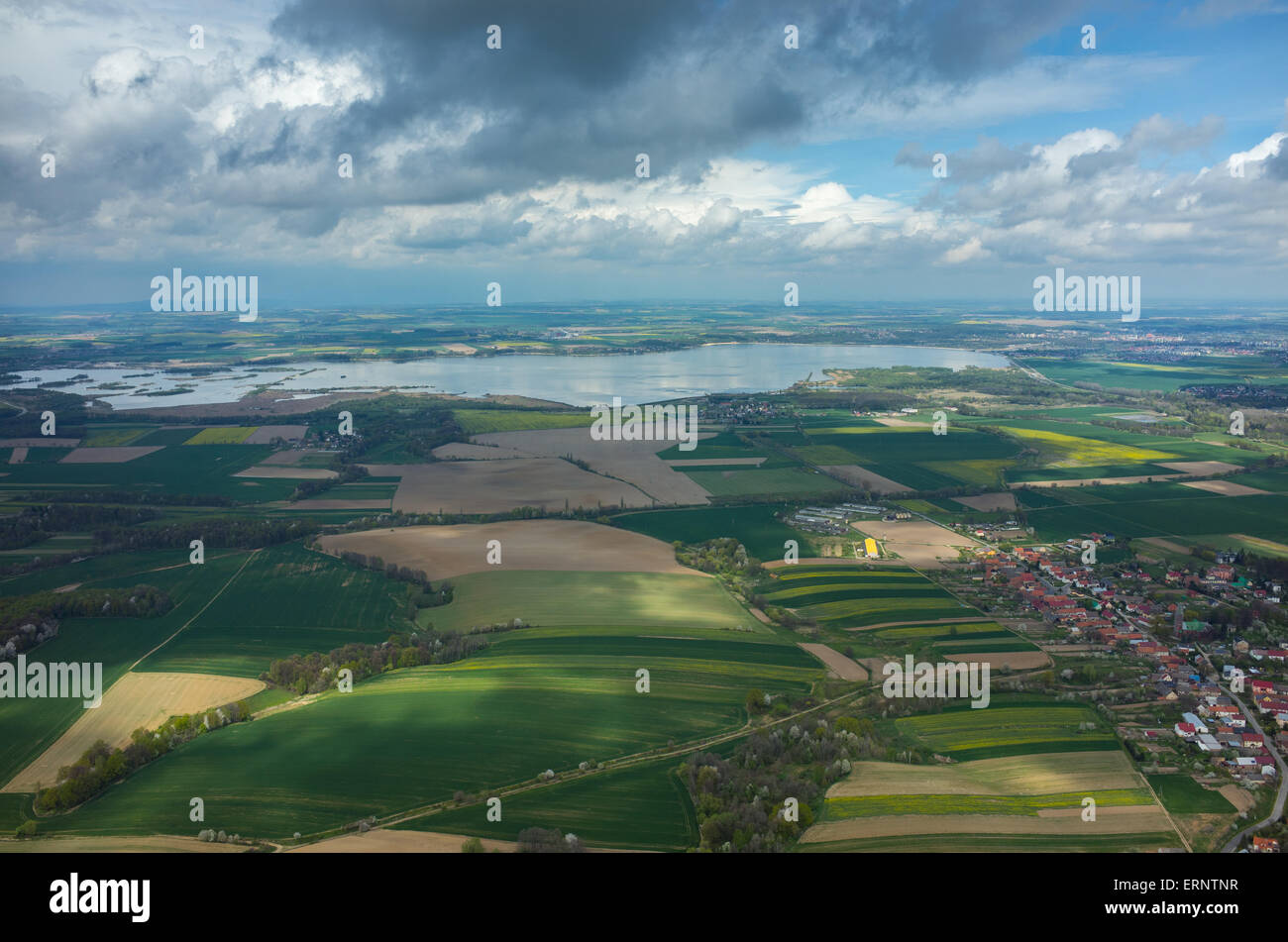 Aerial view on a lake surrounded by green fields Stock Photo - Alamy