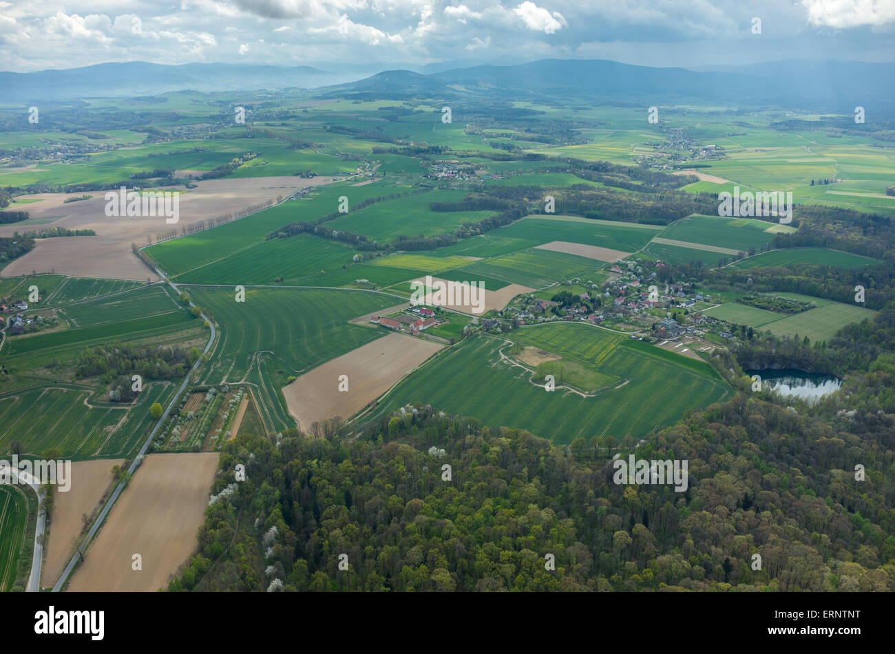 Aerial view on a small village surrounded by green fields Stock Photo ...