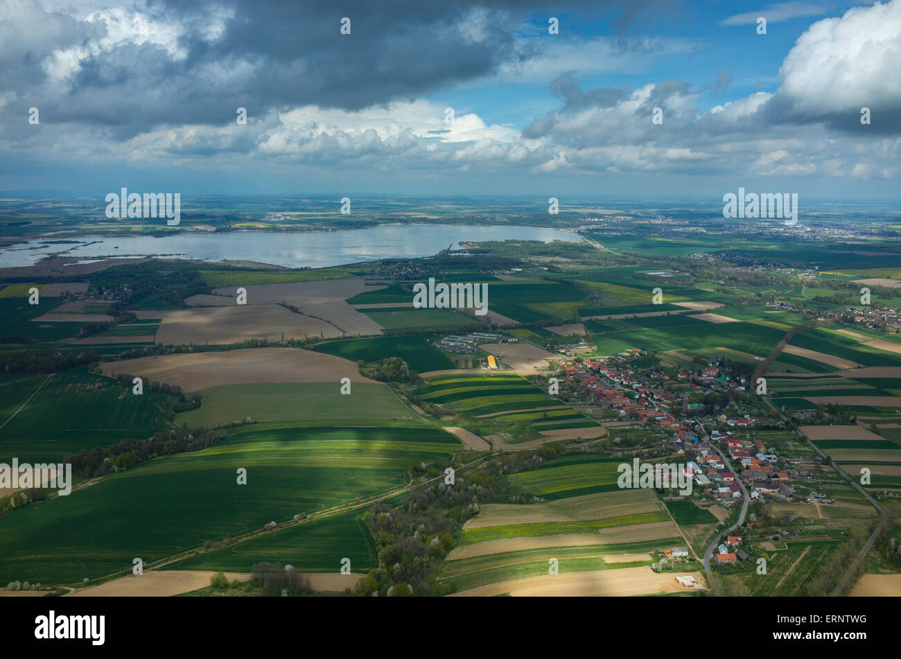 Aerial view on a small village surrounded by green fields Stock Photo ...