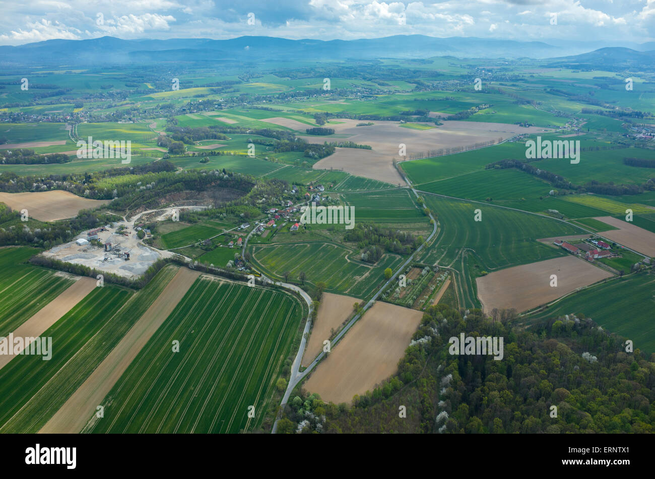 Aerial view on a small village surrounded by green fields Stock Photo ...