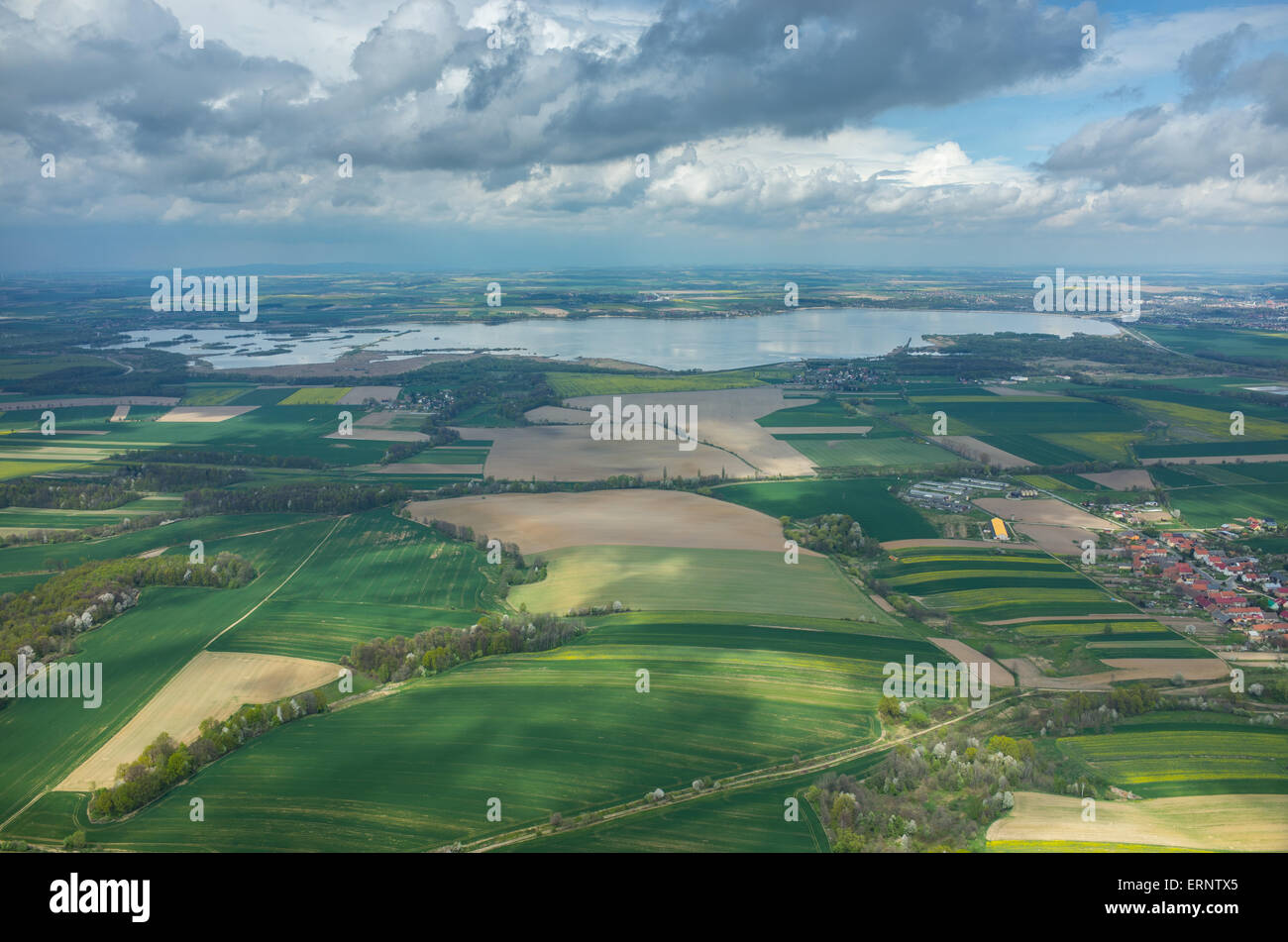 Aerial view on a lake surrounded by green fields Stock Photo - Alamy