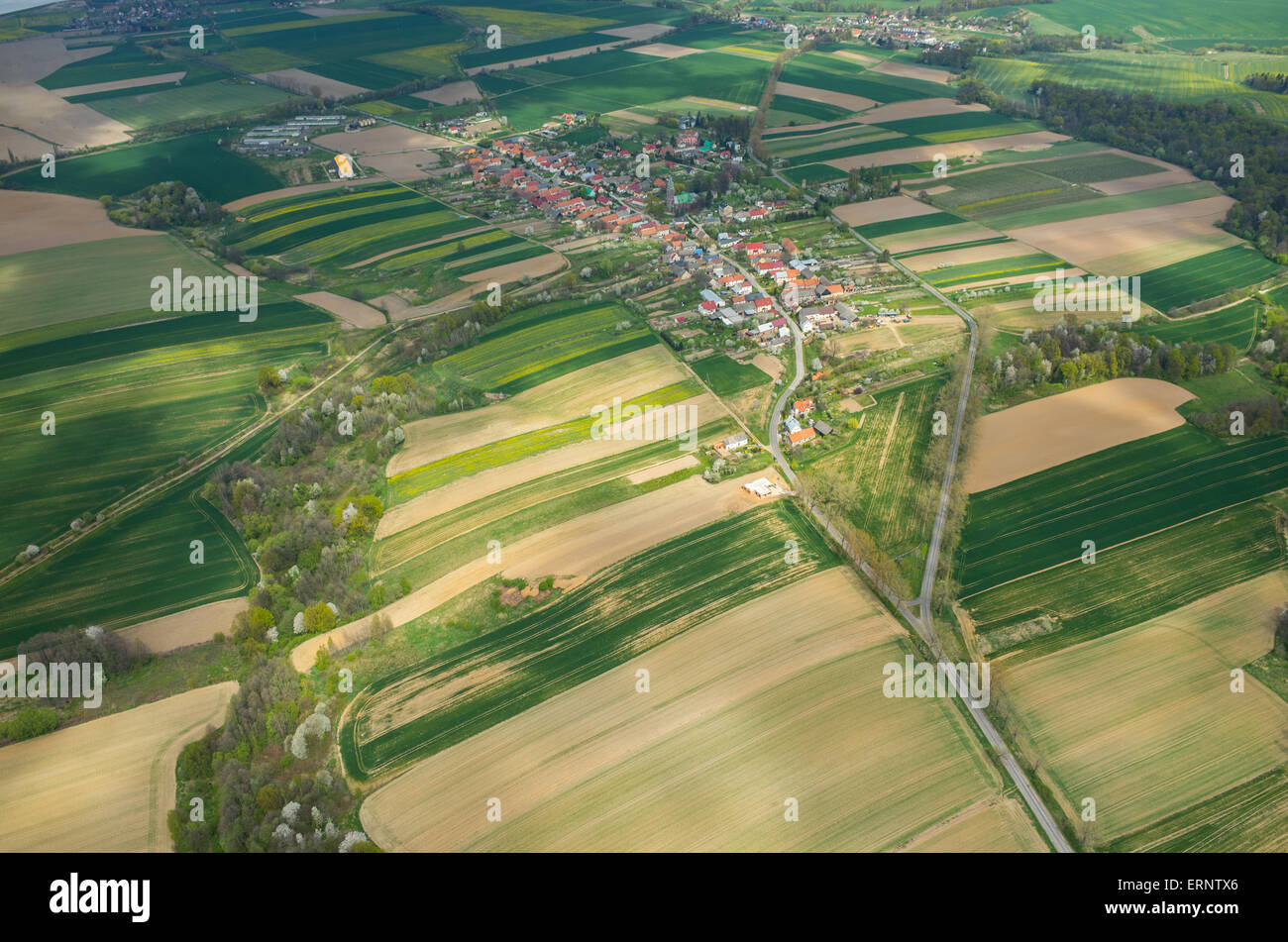 Aerial view on a small village surrounded by green fields Stock Photo ...