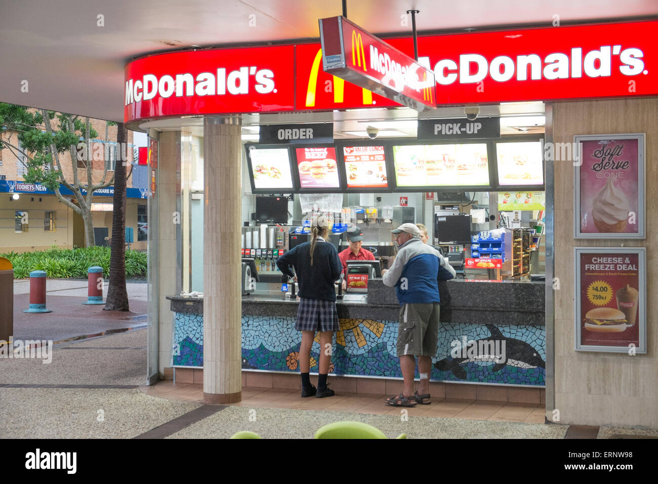 man and a school girl ordering a meal from a Mcdonalds cafe in Port Macquarie,New south wales,australia Stock Photo