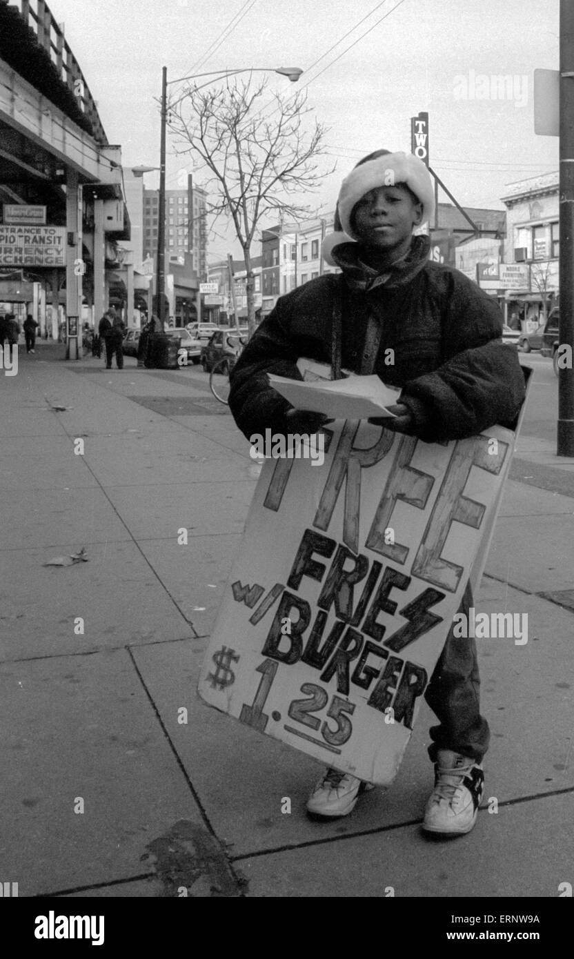 Chicago, IL, 14-Dec-1996: An Afro-American boy is advertising for a restaurant in Uptown Chicago. Stock Photo