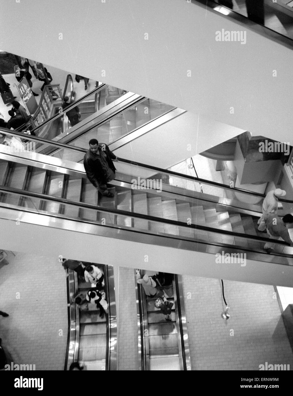 Chicago, IL, 14-Dec-1996: A lonely man on an escalator at Marshall Field's department store on Michigan Ave. Stock Photo