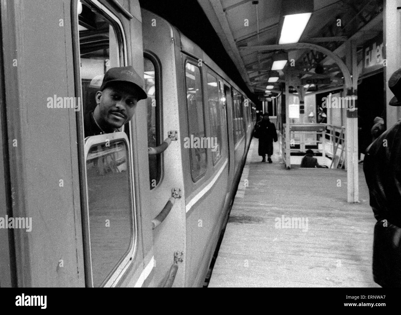 Chicago, IL, 22-Feb-1997: A train conductor is checking the platform before his  Chicago El Train leaves the nocturnal Fullerton station. Stock Photo