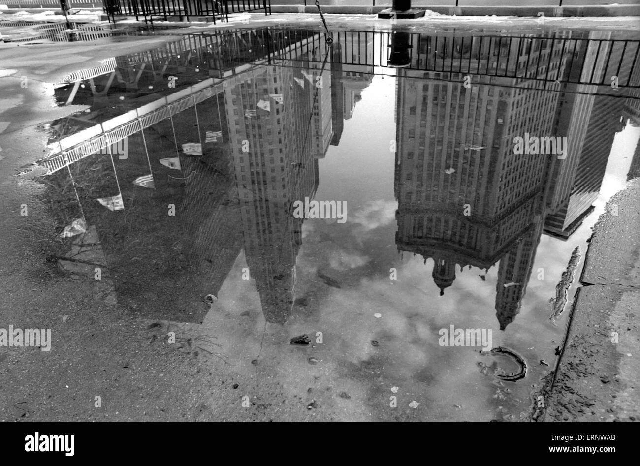 Chicago, IL, 22-Feb-1997: After a rain and snow shower, buildings of North Michigan Ave. / Wacker Drive are reflected in a puddle. Stock Photo