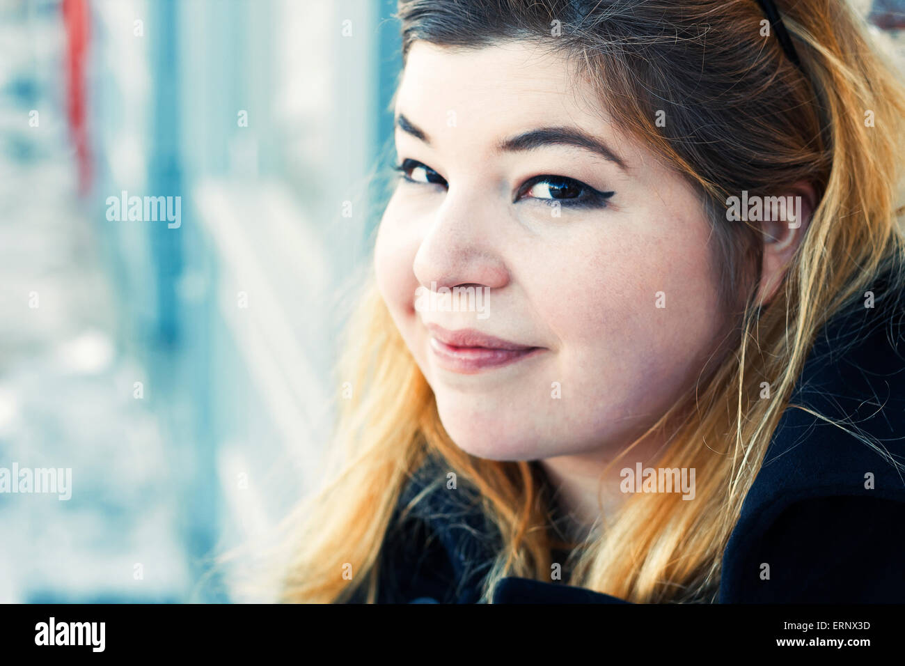Friendly girl early 20s on location going about her everyday life Stock Photo