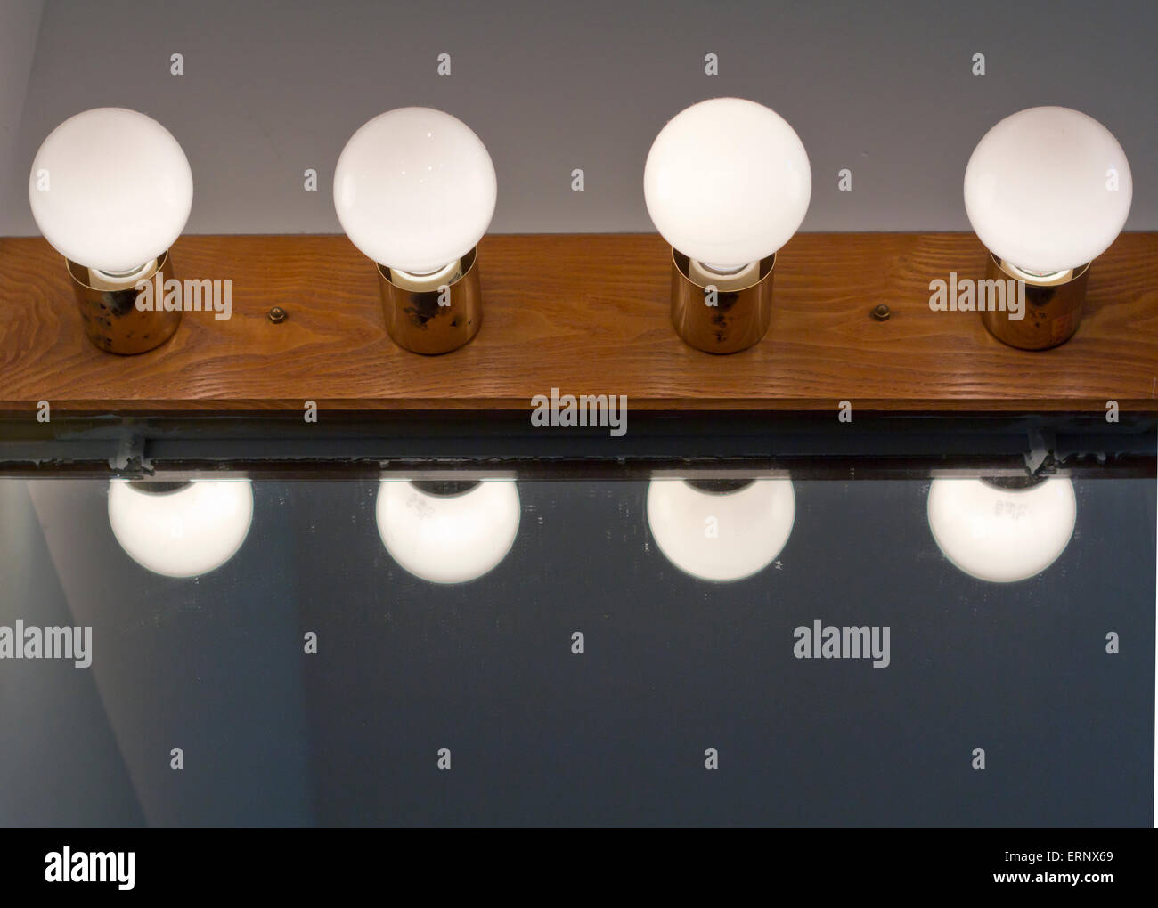 White candelabra globe bathroom bulbs above mirror Stock Photo Alamy