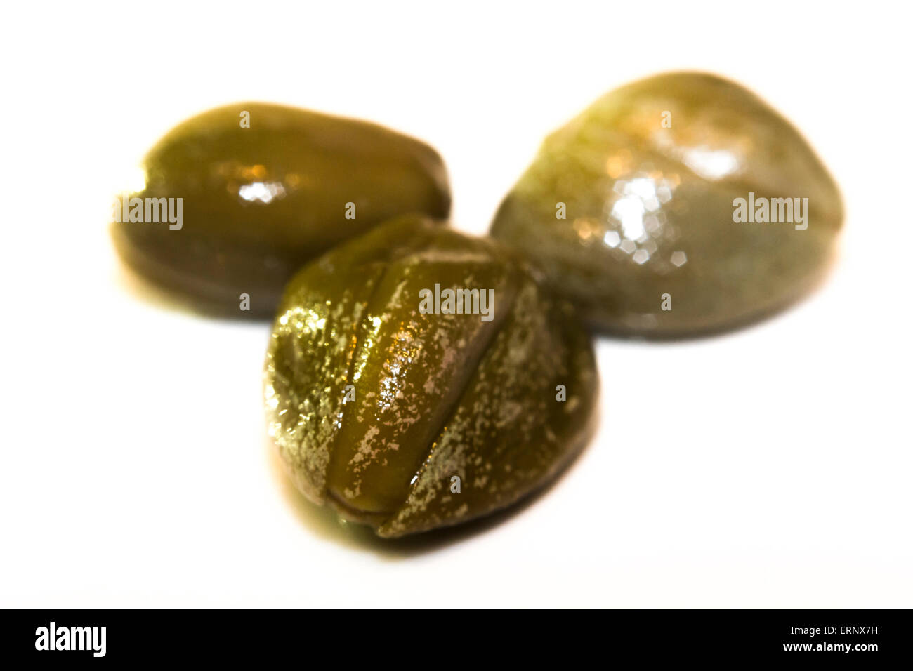 Macro closeup of three Italian capers, edible flower buds Stock Photo