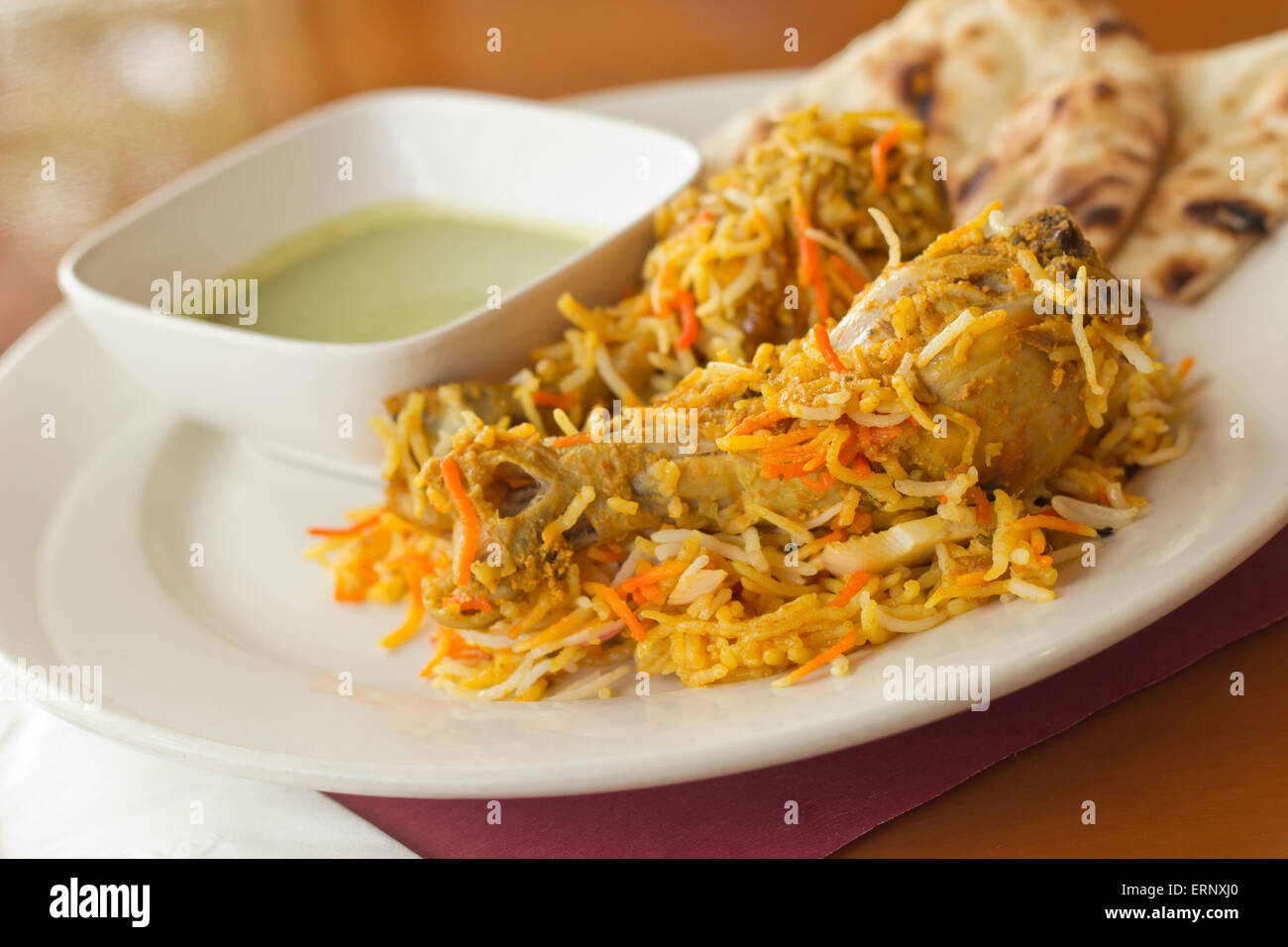 Indian biryani chicken with naan and mint coriander chutney sauce Stock