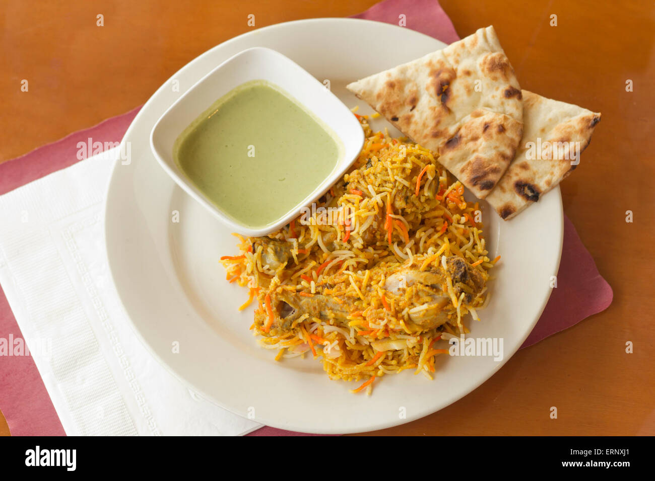 Indian biryani chicken with naan and mint coriander chutney sauce Stock