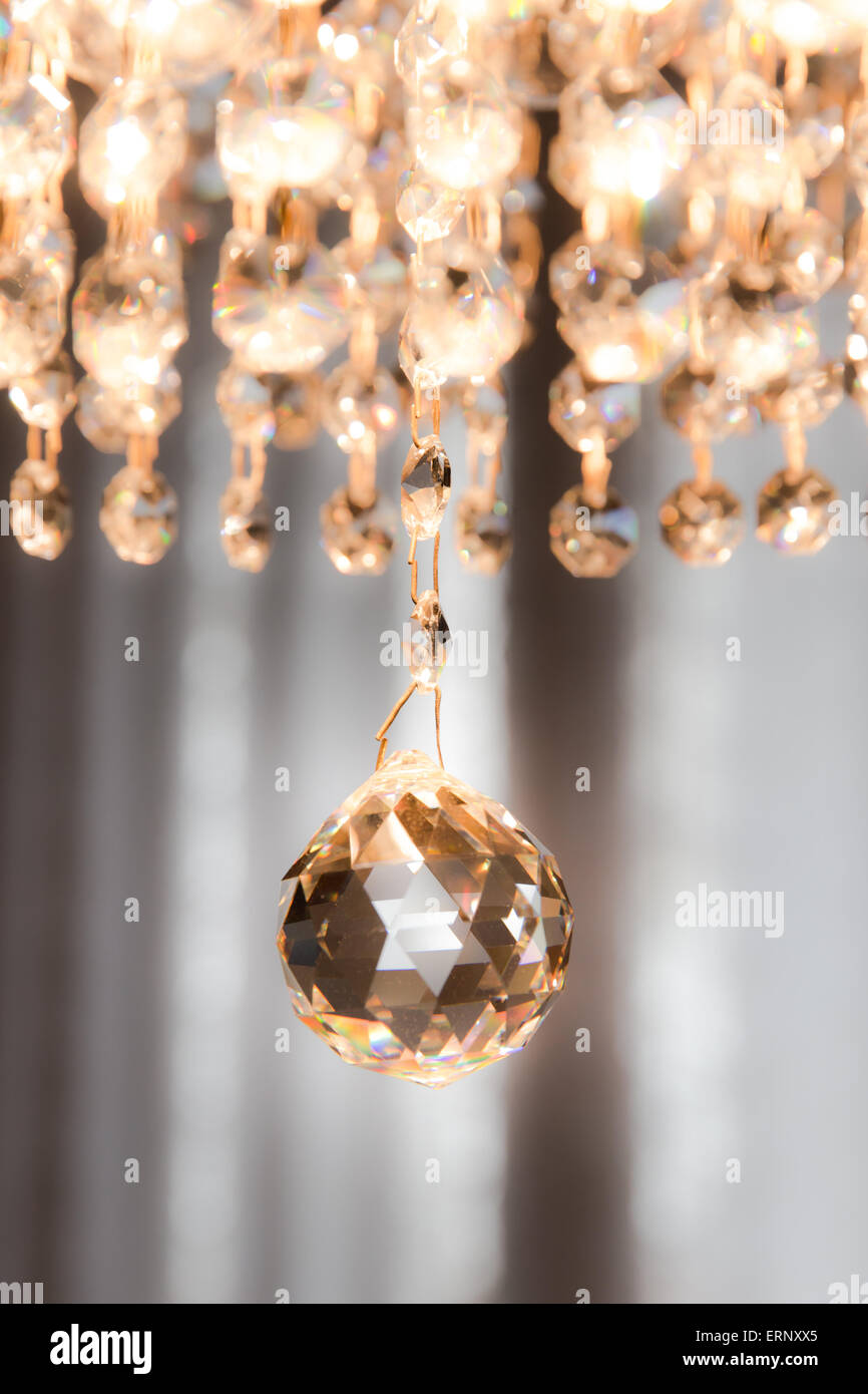 detail of a crystal chandelier that shines with warm light Stock Photo