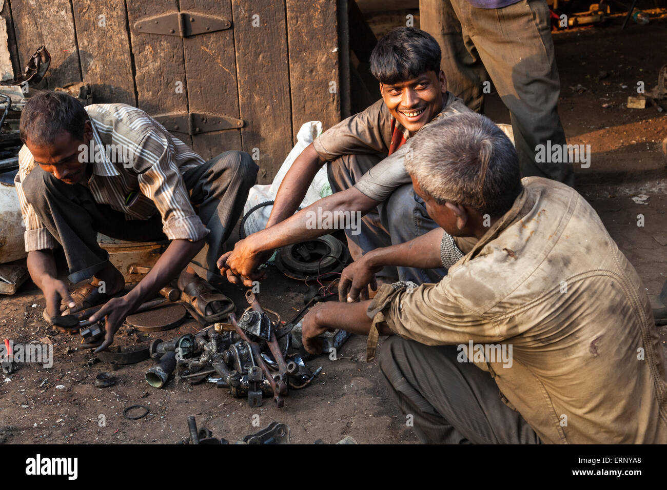 Indian workings sitting together in a market in Mumbai, India Stock Photo