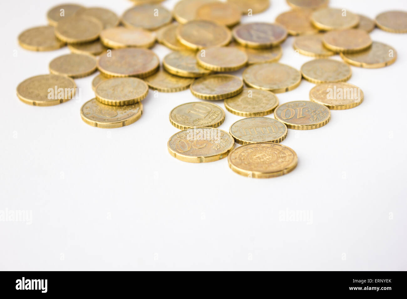 Golden European coins in white background Stock Photo - Alamy