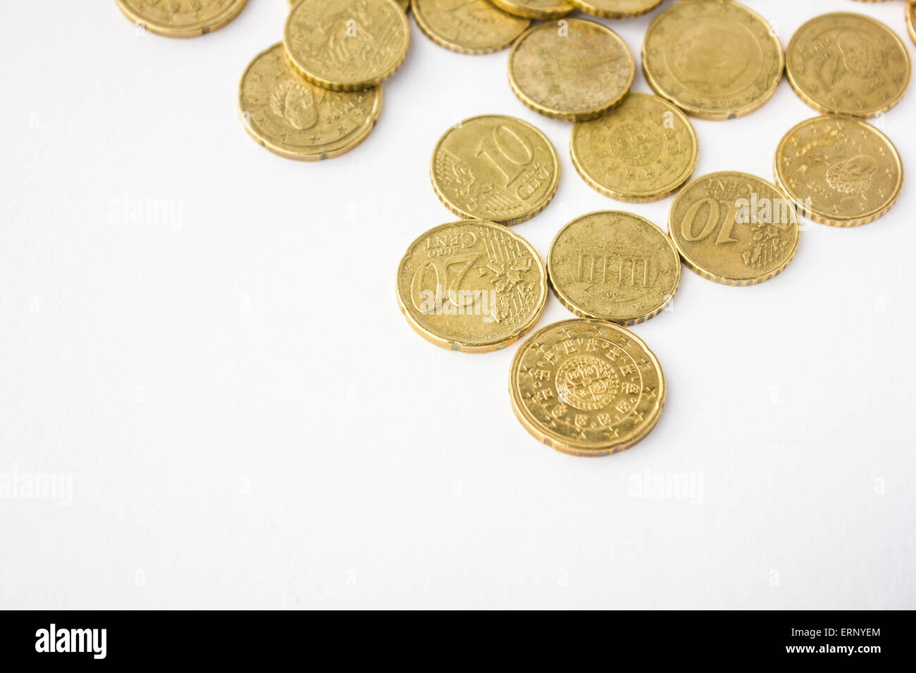 Golden European coins in white background Stock Photo - Alamy