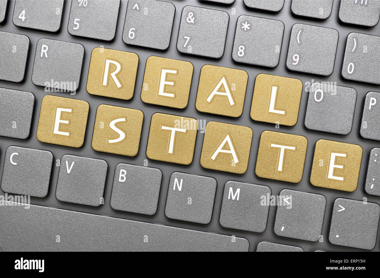 Brown real estate key on keyboard Stock Photo Alamy