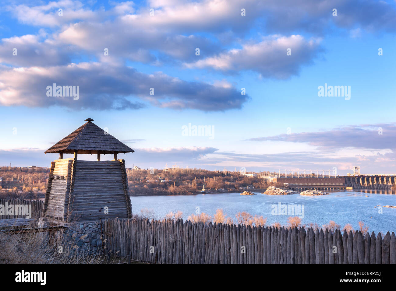 Old wood rustic church building and wooden fence against blue sky at sunset Stock Photo
