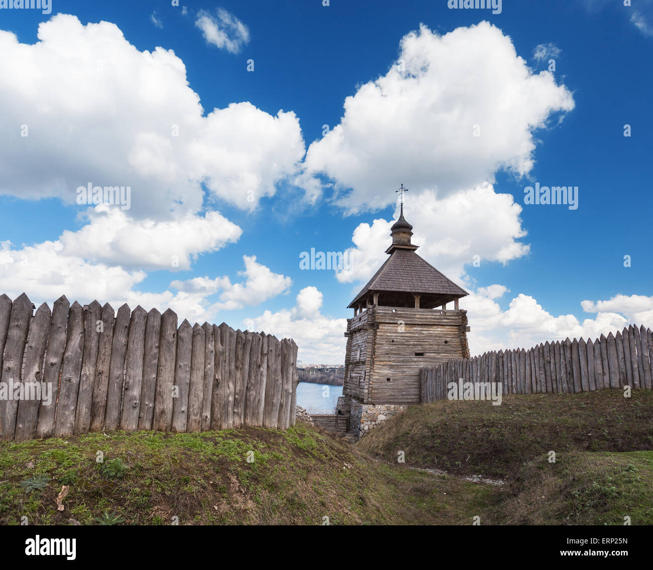 Old wood rustic church building and wooden fence against blue sky at sunset Stock Photo