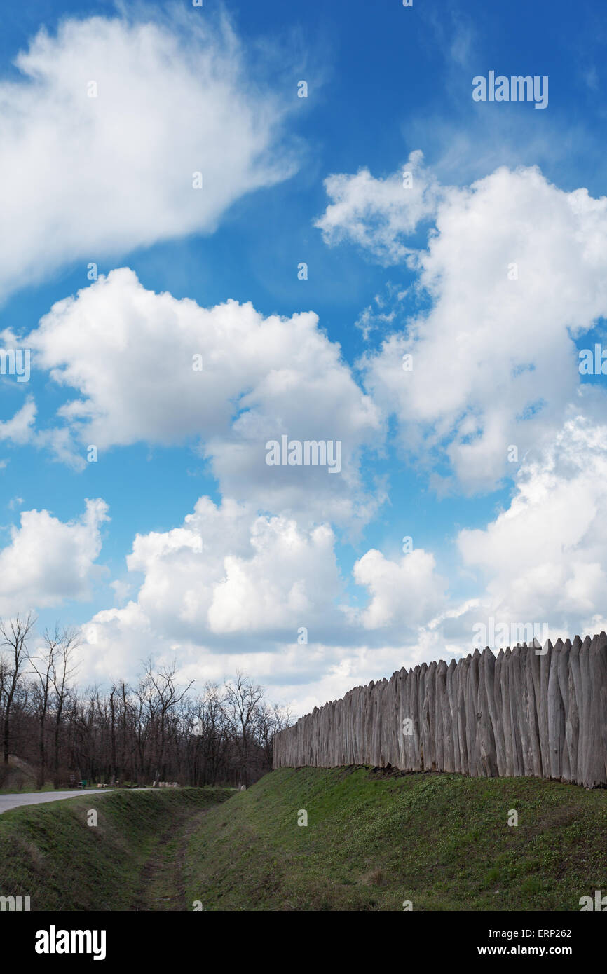 Old wooden fence against blue sky with clouds. Background for design Stock Photo