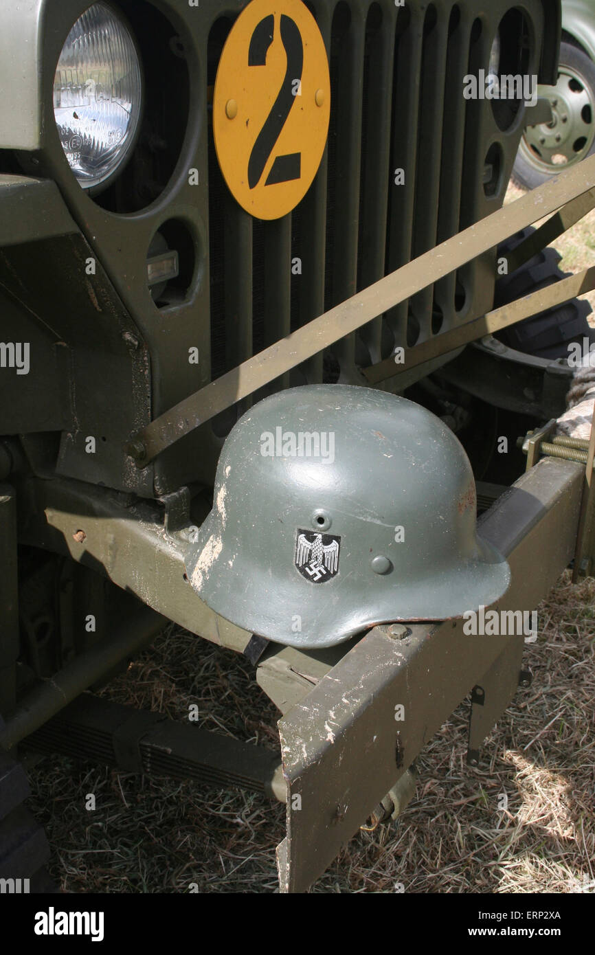Carentan, Normandy, France. 6 June 2015. Reenactment groups recreate Camp Arizona, near to Carentan as part of the D-Day Festival 2015. Here a German helmet is perched on the front of a US army jeep in the camp. This year's D-Day festival commemorates the 70th anniversary of the end of WWII in 1945. Credit:  Daniel and Flossie White/Alamy Live News Stock Photo