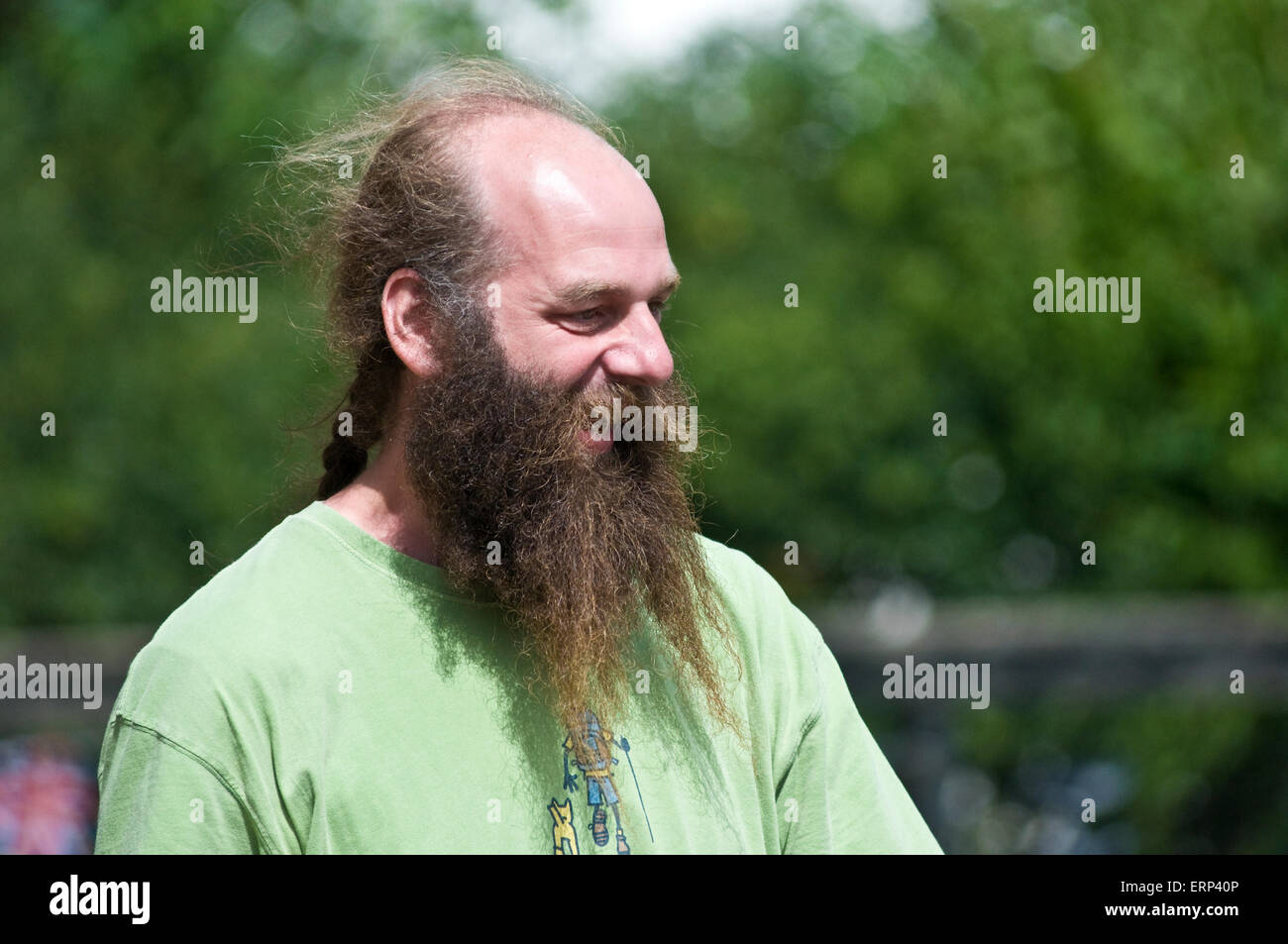 A man with a bald head but a very long beard and a pony tail looks very  content in the English countryside Stock Photo - Alamy