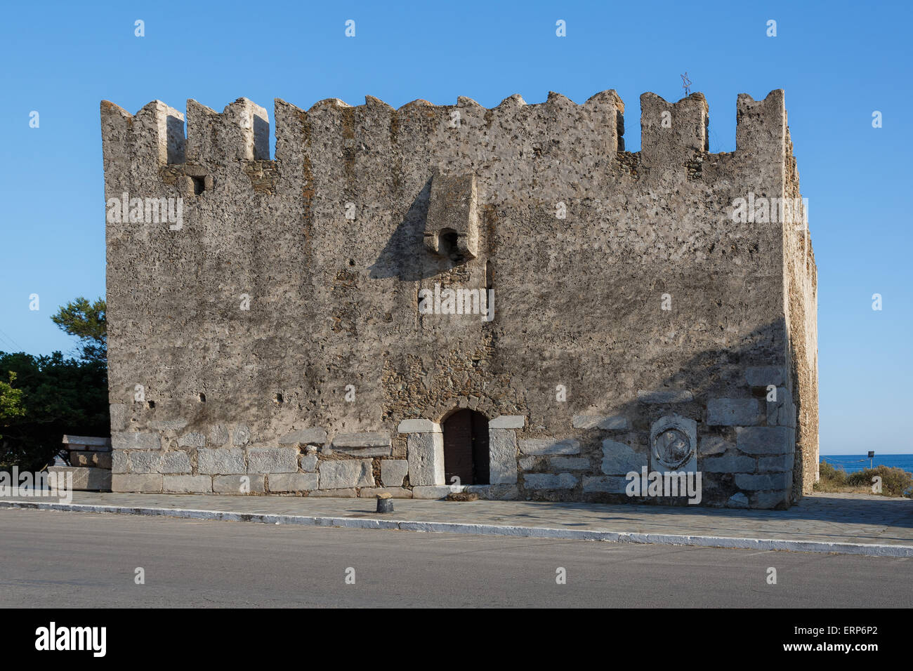 The old venetian castle in Marmari port in Evia, Greece against a blue sky in the afternoon Stock Photo