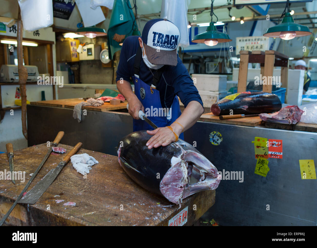 Fresh Tuna main cut by professional Japanese tuna handlers at Tsukiji fish and seafood market, right after the Tuna auction. Stock Photo