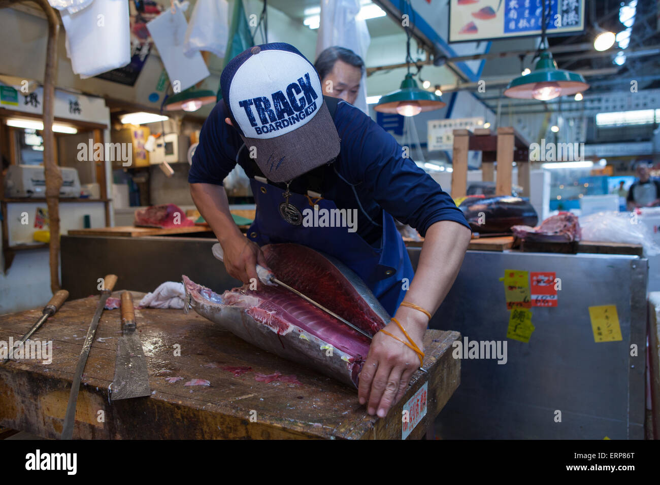 Fresh Tuna main cut by professional Japanese tuna handlers at Tsukiji fish and seafood market, right after the Tuna auction. Stock Photo