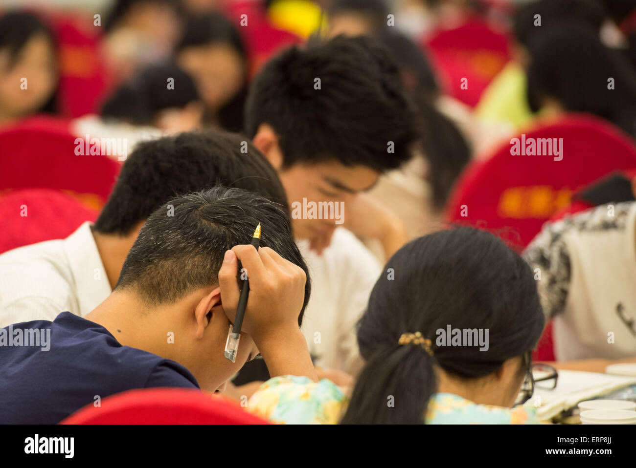 (150606) -- CHONGQING, June 6, 2015 (Xinhua) -- Students prepare for the coming national college entrance exams at the hall of a hotel in Bishan District of Chongqing, southwest China, June 6, 2015, one day before the exams.  About 1300 students of Laifeng High School would attend the exam in Bishan District, a site 20 kilometers away from their school, on June 7 and 8, therefore, most of the students booked hotels near the exam site and prepared for the exam at the last night. (Xinhua/Liu Chan) (zkr) Stock Photo